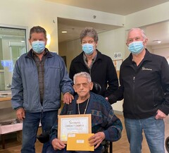 Lloyd Gavel accepts volunteer recognition alongside his nephew Michael Gavel (left), his son Rick Skotnitsky (center) and Sicamous Mayor Terry Rysz.