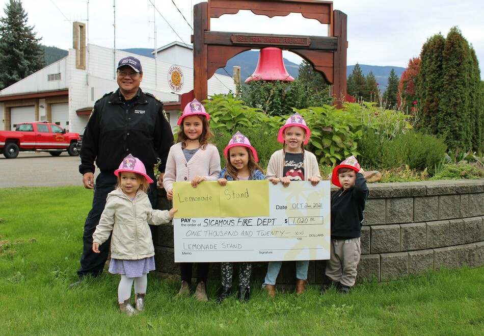 From left: Fire Chief Brett Ogino, Harlowe Bird, 2, Aleeah Bird, 7, Avery Sanche, 5, Kennedy Sanche, 7, and Jase Sanche, 2.