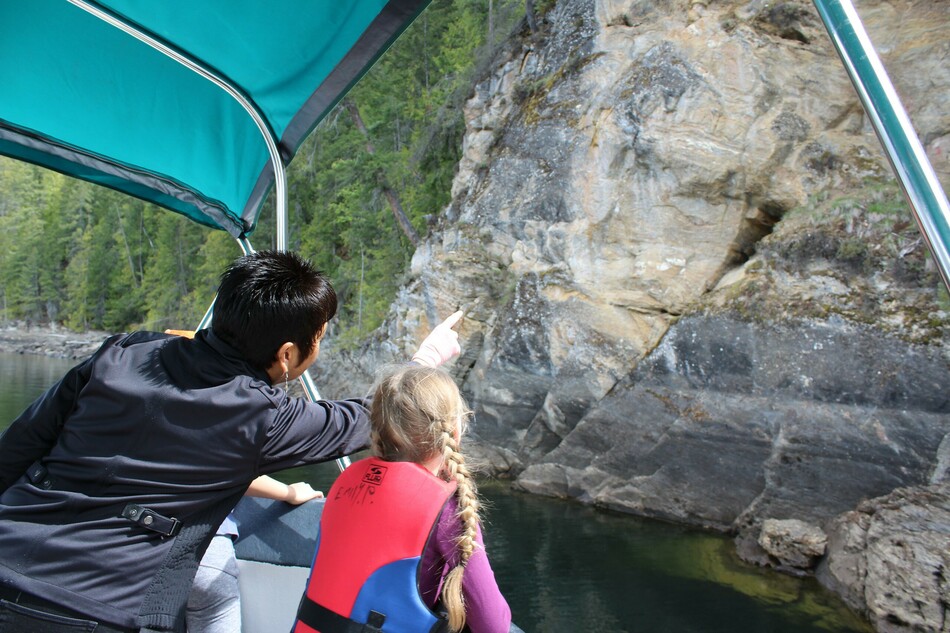 Splatsin Elder and former Chief, Gloria Morgan, points out Secwépemc pictographs to students on Shuswap Lake.